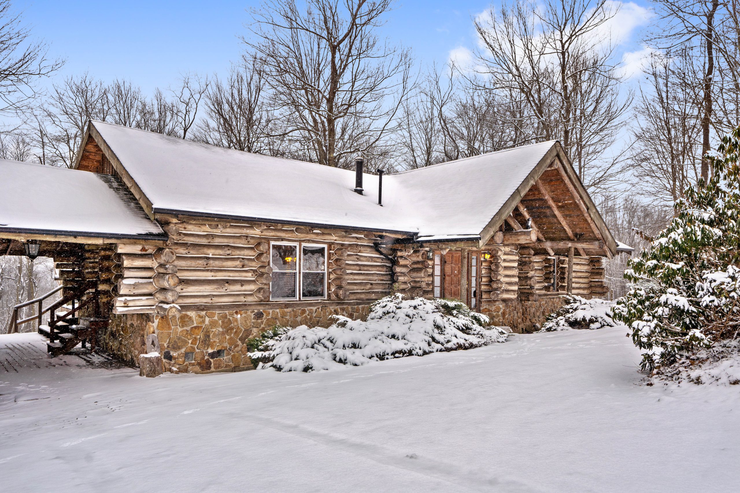 Log cabin vacation rental covered in snow near Ohiopyle, Pennsylvania